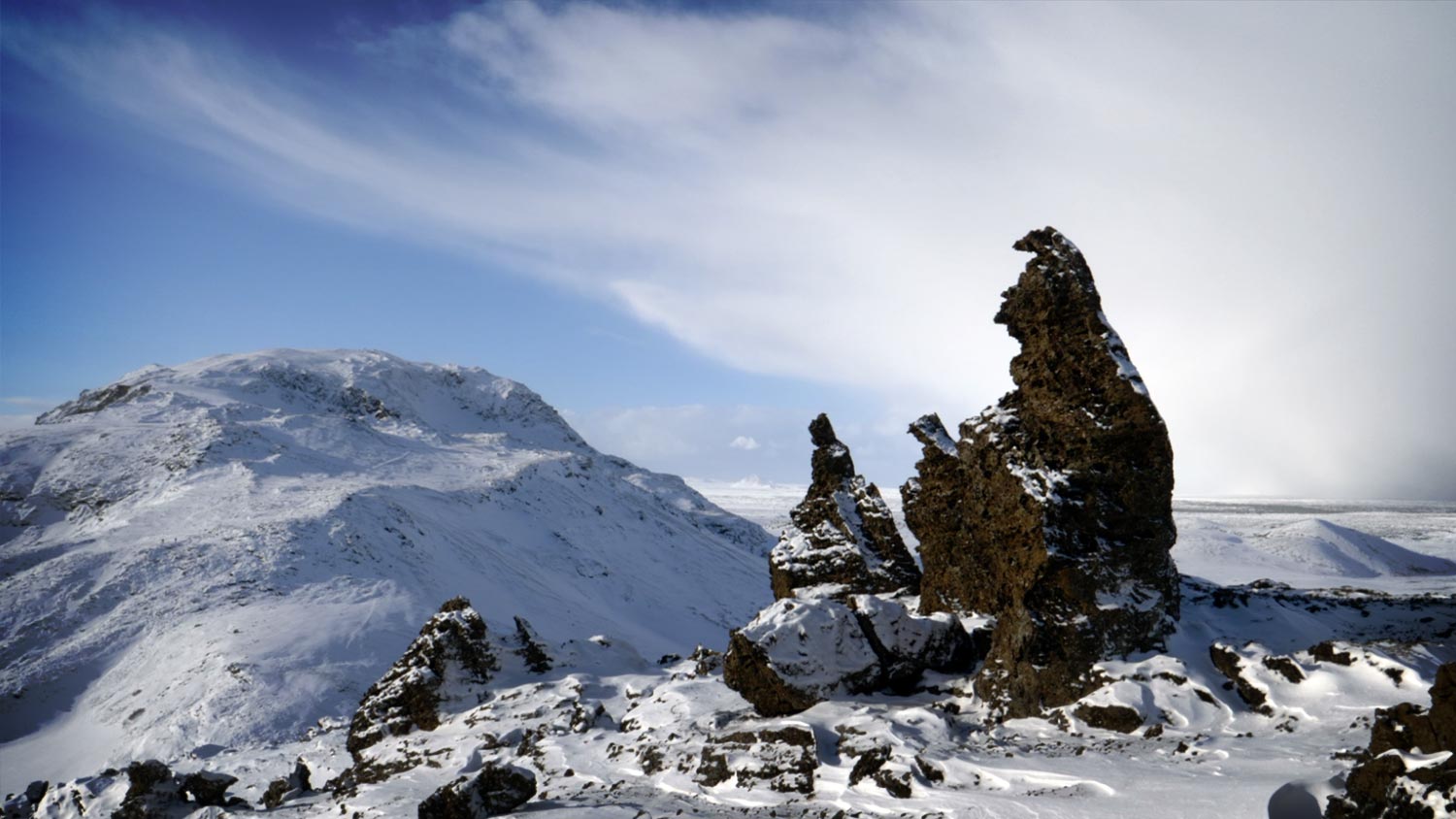 Rocks in a human shape on a top of a snowy mountain